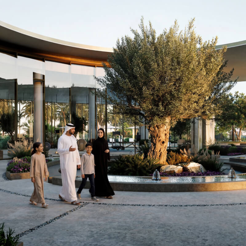 Fay Valley Phase 2 community clubhouse exterior with pools and landscaping, Masdar City